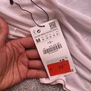 Never worn bodysuit. Pale pink. See through material